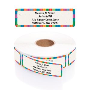 A roll of personalized address labels featuring a colorful striped border, shown inside a clear round dispenser with a graphic overlay.