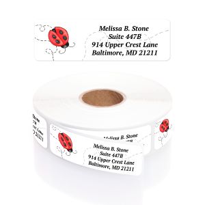 A rectangular personalized address label displayed above a large roll of matching labels, featuring a cute illustrated ladybug with a dotted trail.