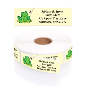 A rectangular personalized address label displayed above a large roll of matching labels, featuring a cute cartoon green frog sitting near a bee.