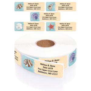 A paper roll of seashell-themed address labels showcasing rotating beach illustrations like starfish and conch shells with clean typography.