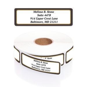 A rectangular personalized address label displayed above a large roll of matching labels, featuring an elegant, classic black and gold border.