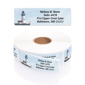 A paper roll of lighthouse-themed address labels showcasing a coastal lighthouse illustration beside a four-line text layout template.