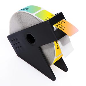 A roll of personalized address labels showcasing a vibrant, cascading gradient of bright colors, housed inside a sleek black Kannon dispenser.