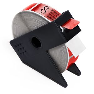 A roll of red foil return address labels feeding through a black Kannon plastic dispenser, showcasing elegant script typography.