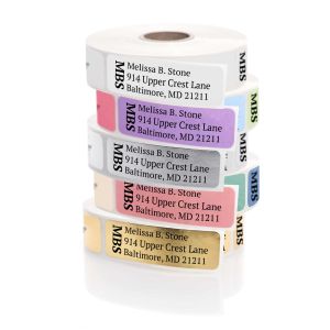 A stack of colorful rolled address labels in white, pink, purple, red, and yellow, each featuring a bold vertical monogram and custom text.