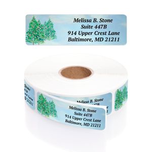 Single winter trees address label with snow-covered evergreen pine trees displayed above a roll of personalized return address labels.