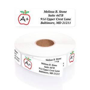 A personalized return address label with a red A+ grade graphic and green apple icon, shown resting above its matching label roll.