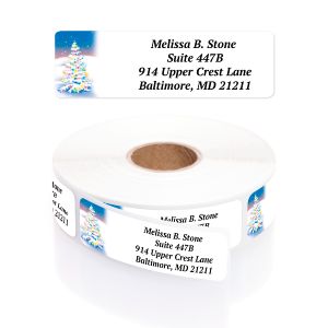 A paper roll of festive address labels showcasing a colorful, snowy Christmas tree illustration beside a clean four-line text layout template.