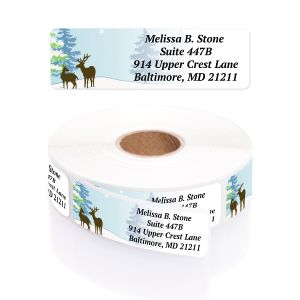Single festive deer address label with silhouette deer and pine trees displayed above a roll of personalized return address labels.