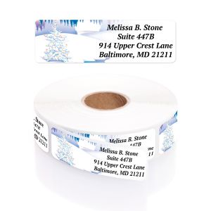 Winter wonderland personalized return address label featuring a decorated Christmas tree and snowy evergreen trees beside printed text.
