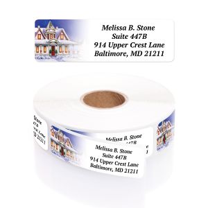 Roll of Victorian holiday address labels displaying a snowy Christmas house illustration beside personalized name and address text.