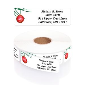 Festive Foursome address label displayed above a roll of custom return address stickers featuring a red holiday ornament graphic.