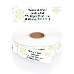 Roll of personalized address labels featuring light blue and yellow snowflake accents alongside a single label with custom address text.