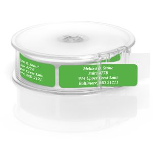 A paper roll of vibrant green address labels featuring a crisp white typography layout template, housed inside a clear round plastic dispenser.