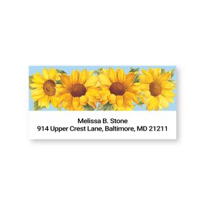 A rectangular personalized address label showcasing a vibrant header of bright yellow sunflowers against a soft blue sky with custom text below.