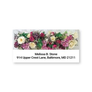 A close-up of a rectangular address label showcasing an elegant banner of pink, white, and red Victorian roses next to custom text.