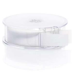 A clear, round plastic address label dispenser holding a roll of blank white rectangular labels, shown from a front three-quarters angle.