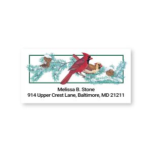 Single personalized return address label featuring a bright red cardinal perched on pine branches above customized name and address text.