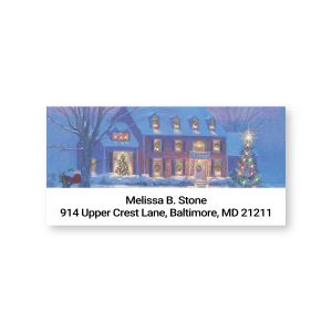 Personalized holiday address label featuring a snowy winter house illustration decorated with Christmas lights above custom address lines.