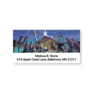 A close-up of a rectangular address label showcasing a beautiful Christmas nativity illustration under a bright star next to custom text.