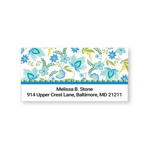 Rectangular address label featuring blue and green floral patterns with leaf accents above custom name and return address text.