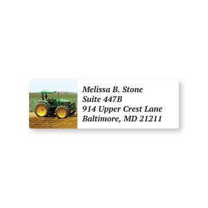 A close-up of a rectangular address label showing a classic green and yellow farm tractor in a field next to clean, custom text fields.