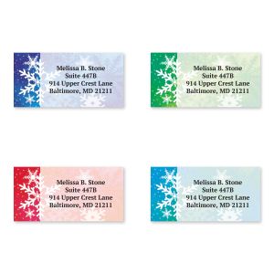 Four personalized address labels in purple, green, pink, and blue, each decorated with intricate snowflake graphics and custom text.