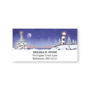Single sheeted address label featuring a snowy winter scene with a glowing lighthouse and pine trees beside custom return address text.