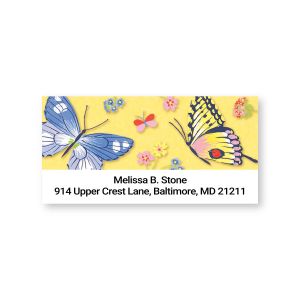 A close-up of a colorful address label decorated with beautiful blue, pink, and yellow butterflies and tiny flowers around custom text lines.