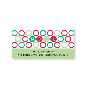 Close-up view of a personalized holiday address label featuring red, green, and teal circles spelling 'NOEL' above custom address lines.