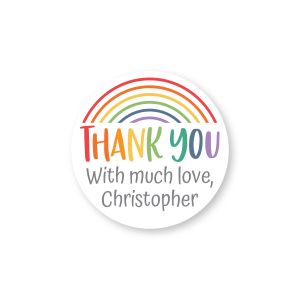 Round personalized label featuring a colorful rainbow above 