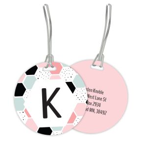 Round pastel geometric monogram luggage tag set showing front design with letter K next to pink back printed with custom contact details.