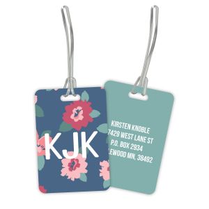 Double-sided plastic luggage tag showing both the floral monogram side and personalized contact information side with flexible straps attached.