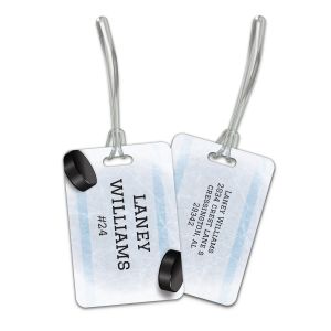 Rectangular plastic luggage tag featuring an ice hockey rink graphic, hockey puck, and custom text 