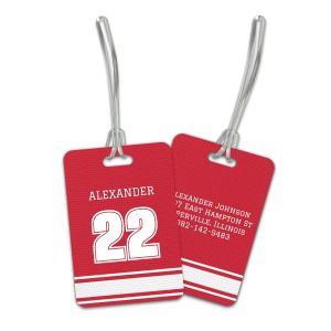 Red and white personalized sports jersey luggage tag set displaying front player name and number next to back contact information.