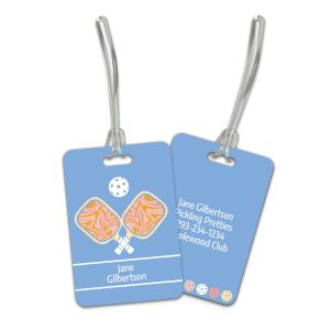 Periwinkle blue retro pickleball bag tag set displaying front graphic with crossed paddles next to back with custom name and contact details.
