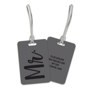 Rectangular dark gray luggage tag with black script text reading 