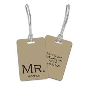 Double-sided tan plastic luggage tag with clear straps showing front side printed with MR. Willingham and back side with custom address details.