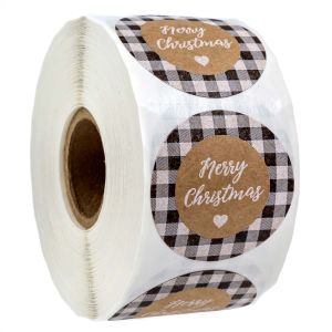 Roll of round kraft paper Christmas stickers featuring a black and white buffalo plaid pattern with 'Merry Christmas' text and a small heart.