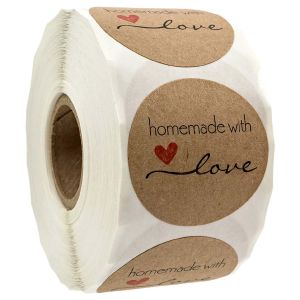 A tight roll of round natural brown kraft stickers featuring black script that reads homemade with love and a small red heart.