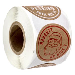 A large paper roll of round kraft brown Christmas stickers displaying a red ink vintage Santa Claus illustration with Naughty or Nice typography.