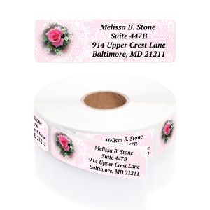 A large roll of white address labels featuring an elegant pink rose illustration with green leaves alongside a clean, traditional typography layout.