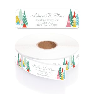 Single personalized address label with geometric holiday trees displayed above a rolled coil of printed return address stickers.