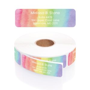 A close-up of a rolled address label featuring a vibrant pastel rainbow watercolor background with a clean, centered white text layout.