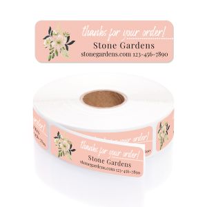 A pink paper roll of business labels featuring a charming floral bouquet, elegant script layout, and personalized company contact details.
