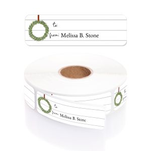 A white paper roll of holiday gift tags featuring a rustic green magnolia wreath design on a subtle white wood shiplap background template.