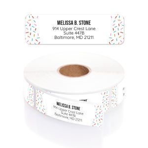 A roll of personalized Bright Party Sprinkles address labels featuring colorful sprinkle confetti side borders with custom name and address text.