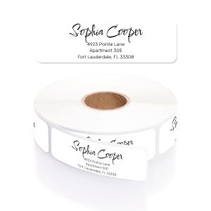 A roll of personalized white address labels showcasing an elegant black cursive font for the name and clean block text for the address layout.