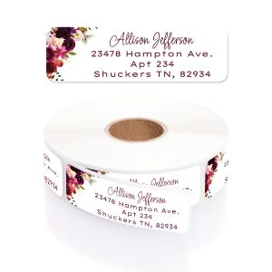 Five unique watercolor floral address labels displayed in a grid, showing bright botanical borders and personal text in a rustic purple font.