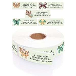 A rectangular personalized address label displayed above a large roll of matching labels, featuring a charming, colorful folk-art butterfly.